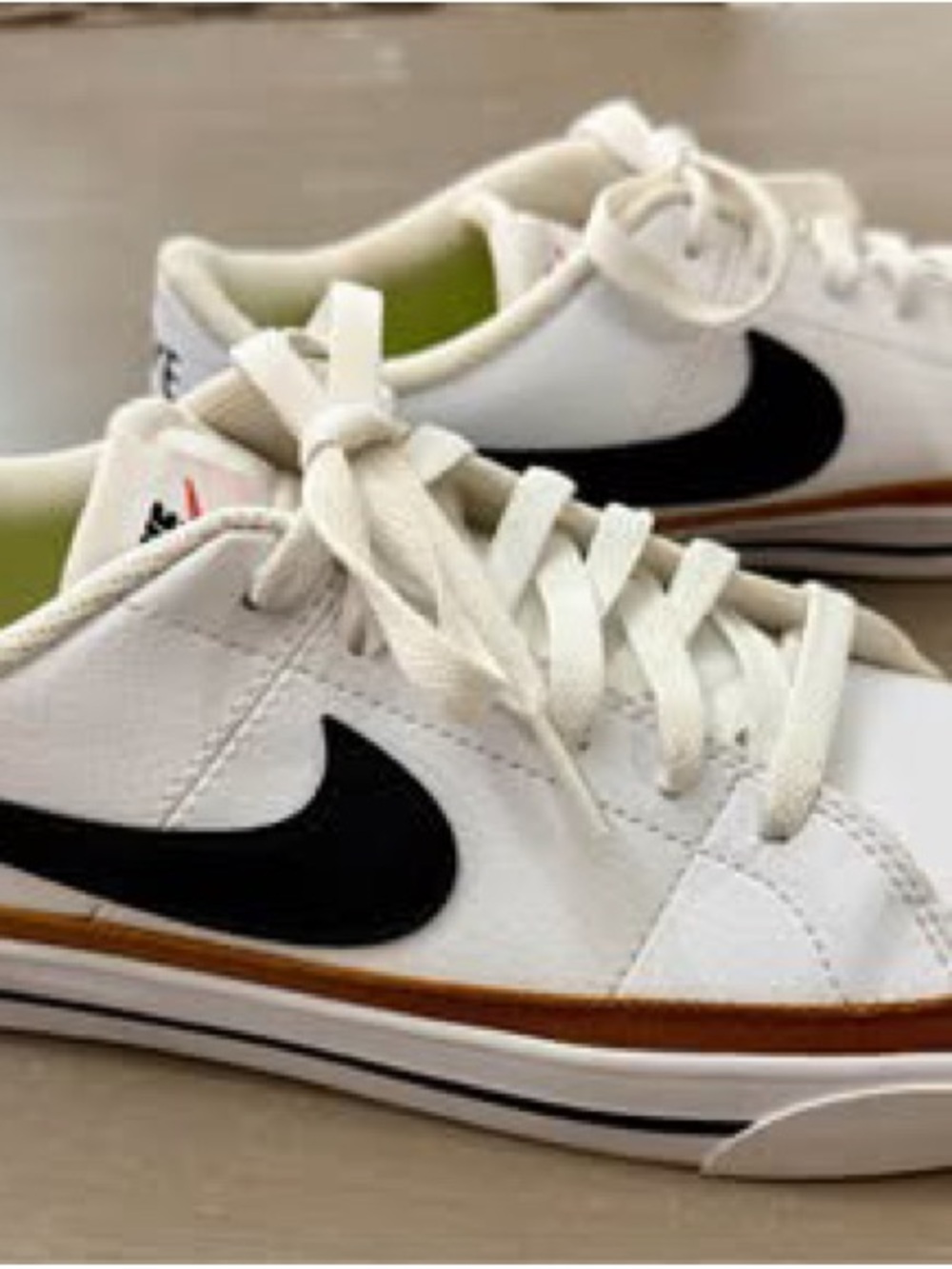 Nike White Low-Top Sneakers with Black Swoosh and Brown Midsole Stripe